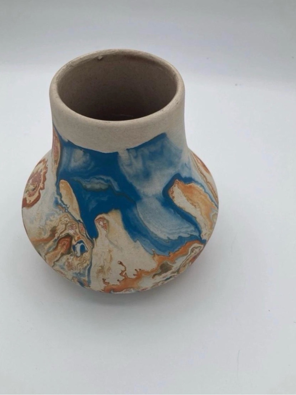 Nemadji Pottery handcrafted ceramic vase with blue, orange, and beige marbled